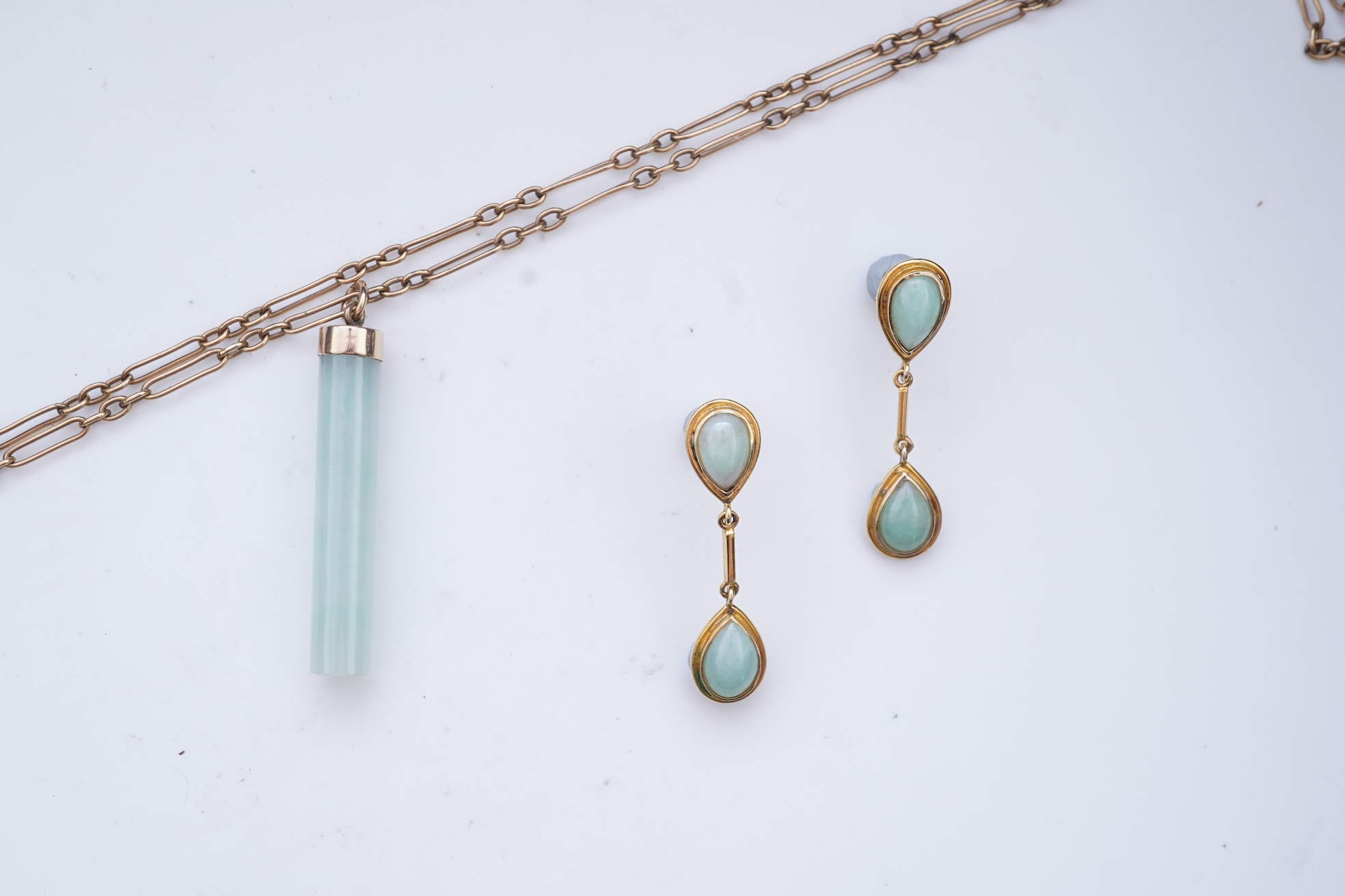 A jadeite pendant and pair of earrings